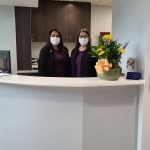 {PRACTICE_NAME} staff at the front desk