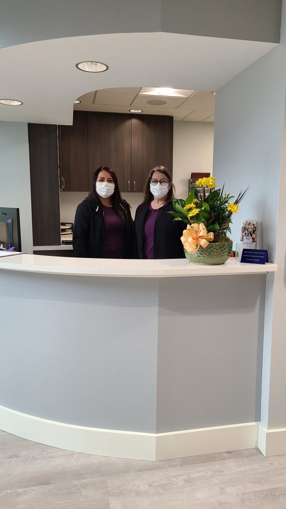 {PRACTICE_NAME} staff at the front desk