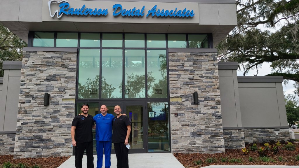 doctors standing in front of {PRACTICE_NAME} office building