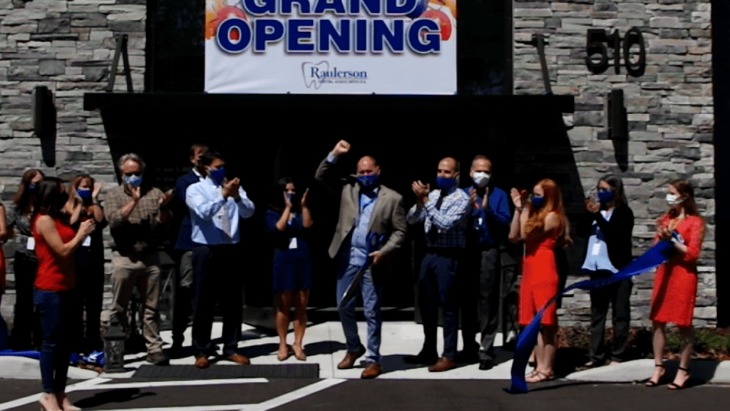 cutting the ribbon at the {PRACTICE_NAME} grand opening