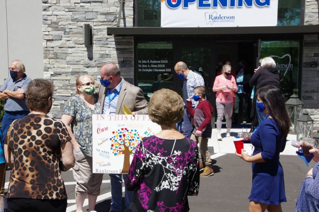 Crowd outside of {PRACTICE_NAME} at the grand opening