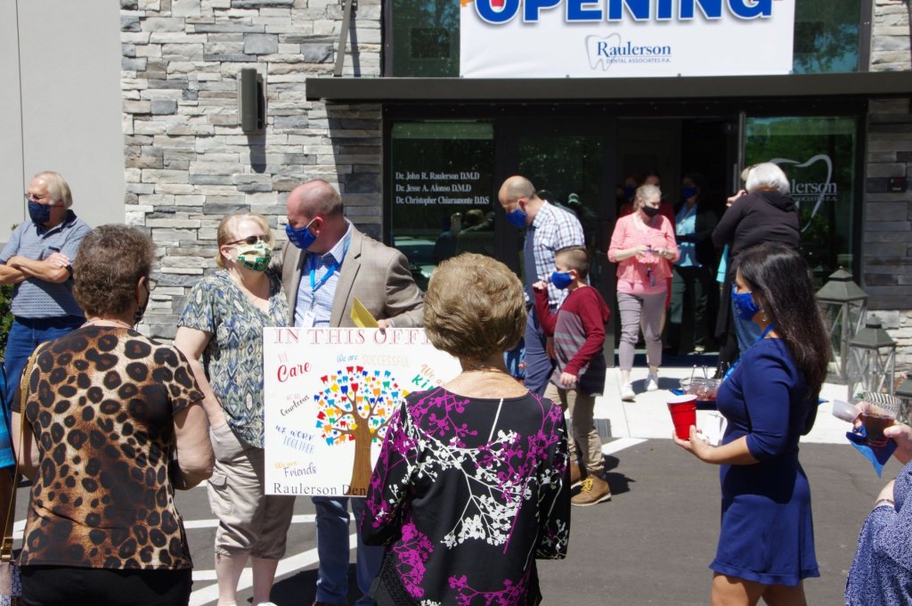 Crowd outside of {PRACTICE_NAME} at the grand opening