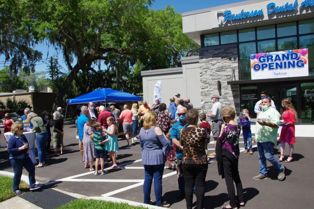 Crowd outside of {PRACTICE_NAME} at the grand opening